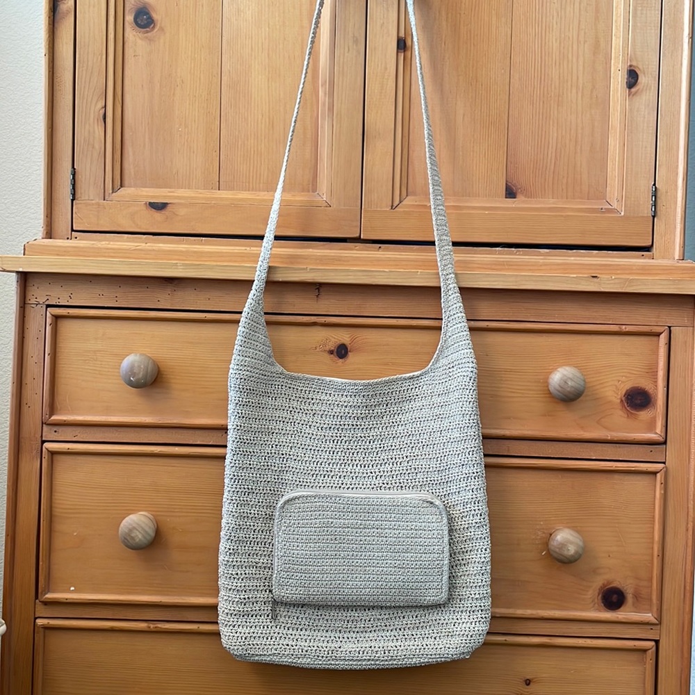 Woven crossbody bag with external zip pocket wallet.